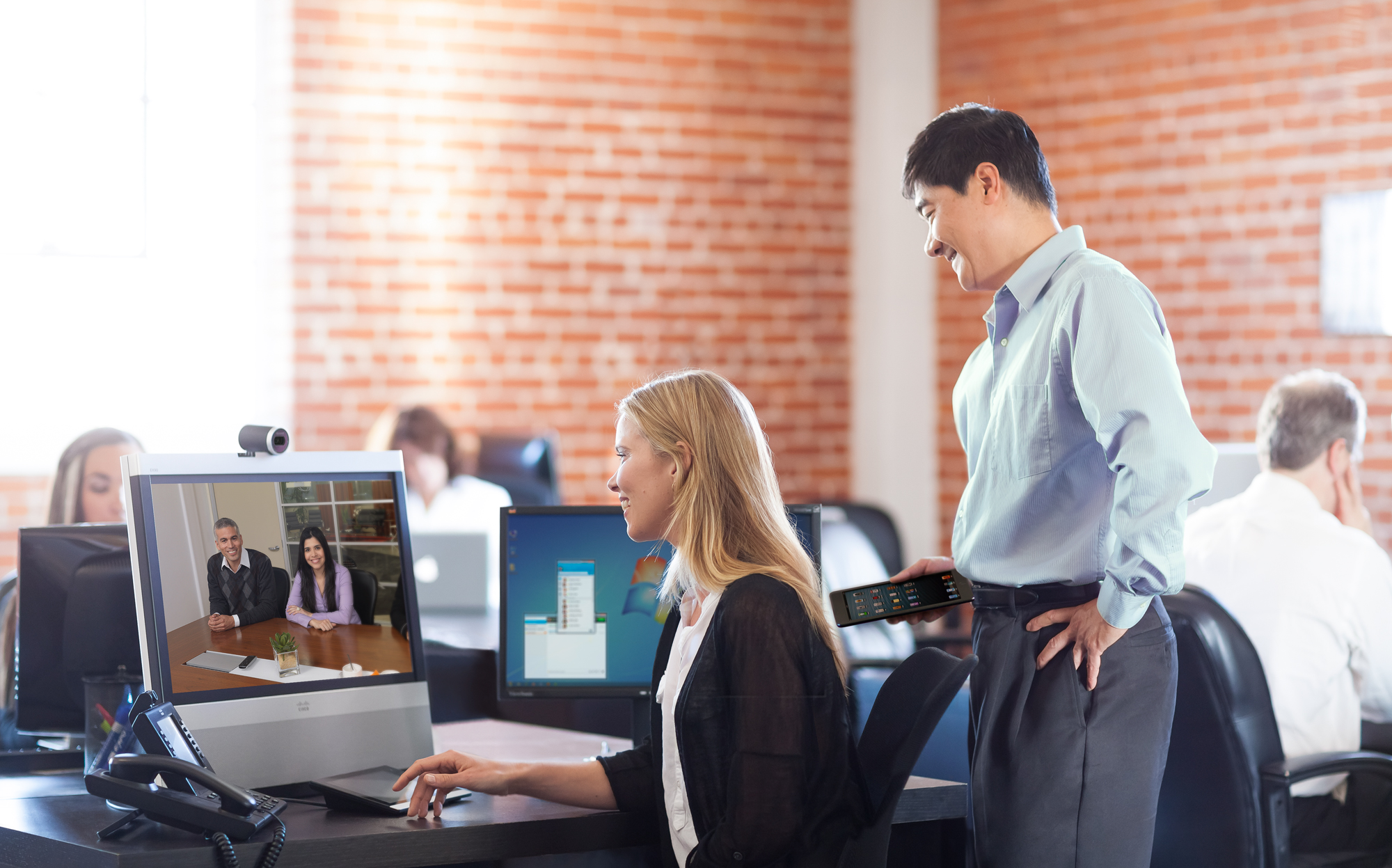Collaborating with employees using Cisco TelePresence. 